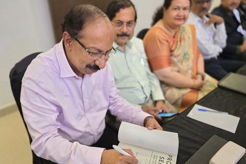 Dr. K.R. Suresh Nair signing a copy of his book Product Sense